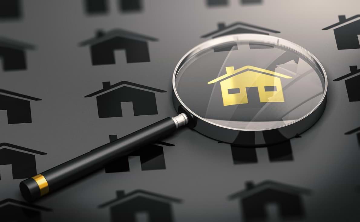 House graphic under a magnifying glass